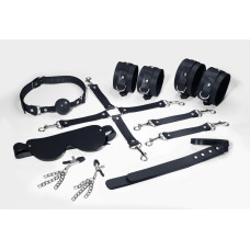 Набір Feral Feelings BDSM Kit 7 Black, наручники, поножі, конектор, маска, паддл, кляп, затискачі